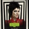 Winona Ryder with spiky black hair and a goth-like appearance in the new character poster and trailer for 'Beetlejuice' movie. The background is black and white boxes